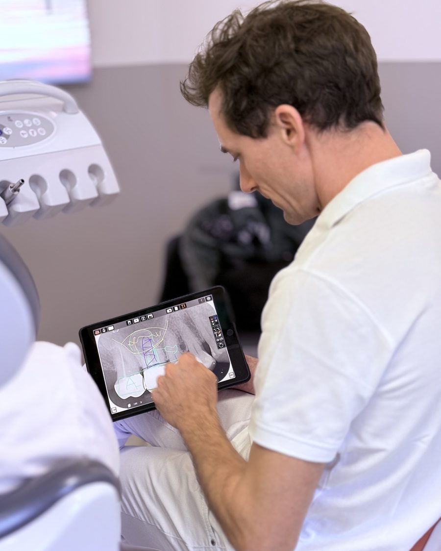 Dr. Dr. Marc Füßinger bespricht Aufnahmen auf dem Tablet